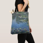 Waterlilies by Claude Monet, Vintage Flowers Tote Bag<br><div class="desc">Beautiful all-over-print tote bags! Available in two styles and two sizes! Water Lilies (1906) by Claude Monet is a vintage impressionism fine art landscape floral painting. It is one of many variations of water lily paintings that Monet painted in his flower garden in Giverny, France. Waterlily flowers in a spring...</div>