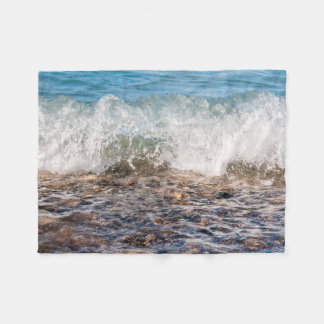 Wave breaking on rocky shore in Michigan Fleece Blanket