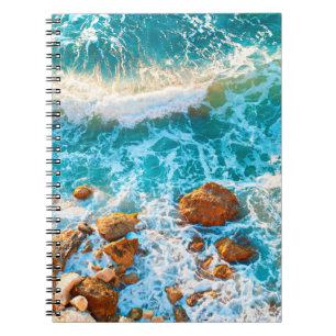 Waves on a rocky beach at sunset. Aerial viewbeach Notebook