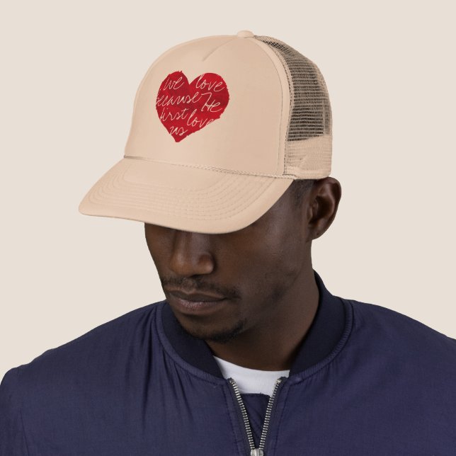 We Love Because He First Beige Trucker Hat (In Situ)