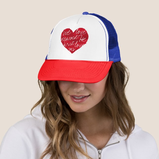 We Love Because He First Red Blue Trucker Hat (In Situ)