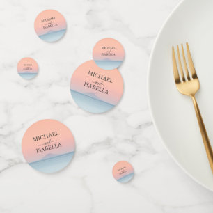 Wedding by the sea under peachy sky sunset confetti
