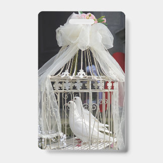 Wedding doves wait for the bride and groom ID badge