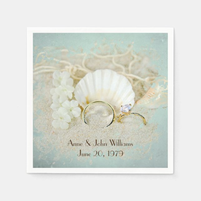 wedding rings and seashells in sand napkin (Front)