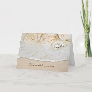 wedding rings on rose petal card
