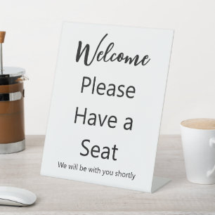Welcome Please Have a Seat White and Black Text Pedestal Sign