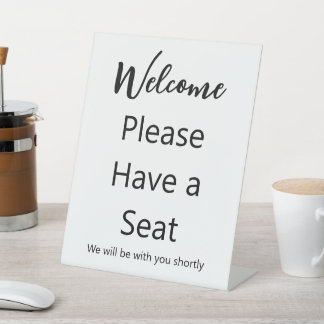 Welcome Please Have a Seat White and Black Text Pedestal Sign