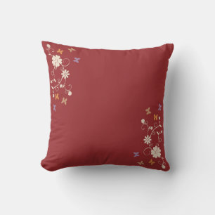 Whimsical Floral and Butterfly Accents on Dark Red Cushion