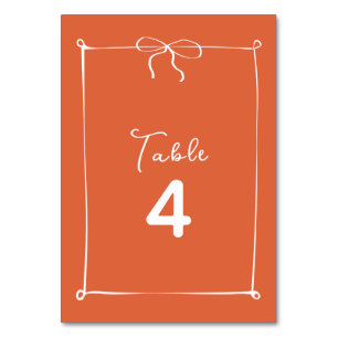 Whimsical Italian Sunset with White Bow Wedding Table Number