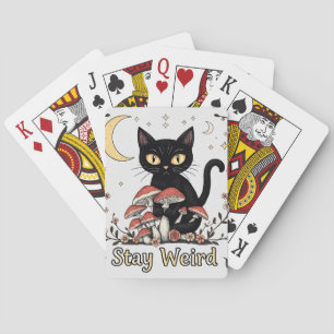 Whimsical noir cat framed by red mushrooms and pal playing cards