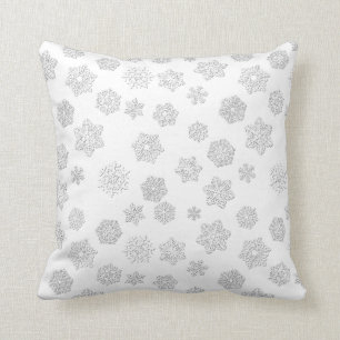 White 3-d snowflakes on a white background cushion