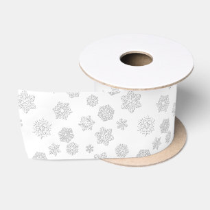 White 3-d snowflakes on a white background satin ribbon