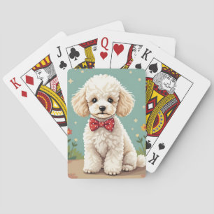 White adorable poodle with bow tie playing cards