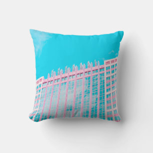 WHITE AND BLUE CONCRETE BUILDING UNDER BLUE SKY CUSHION