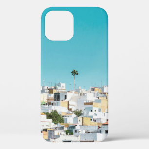 White and brown concrete houses under blue sky in iPhone 12 case