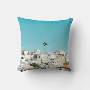 White and brown concrete houses under blue sky in cushion