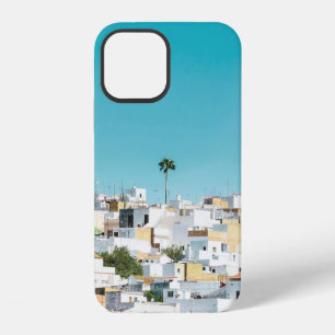 White and brown concrete houses under blue sky in iPhone 12 case