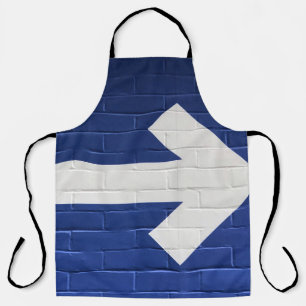 White arrow painted on brick wall apron