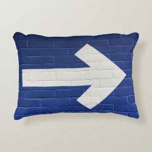 White arrow painted on brick wall decorative cushion
