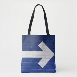 White arrow painted on brick wall tote bag