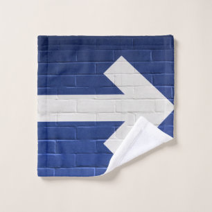 White arrow painted on brick wall wash cloth