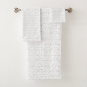 White background with a repeating pattern of small bath towel set
