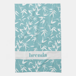 White bamboo leaves on teal background tea towel