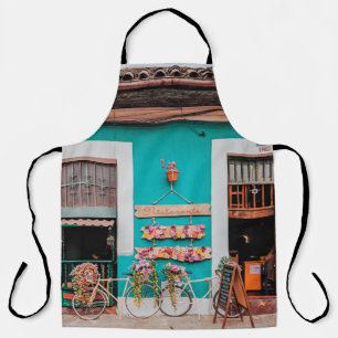 WHITE BICYCLE PARKED BESIDE TEAL PAINTED CONCRETE APRON