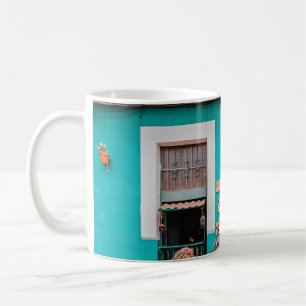 WHITE BICYCLE PARKED BESIDE TEAL PAINTED CONCRETE COFFEE MUG