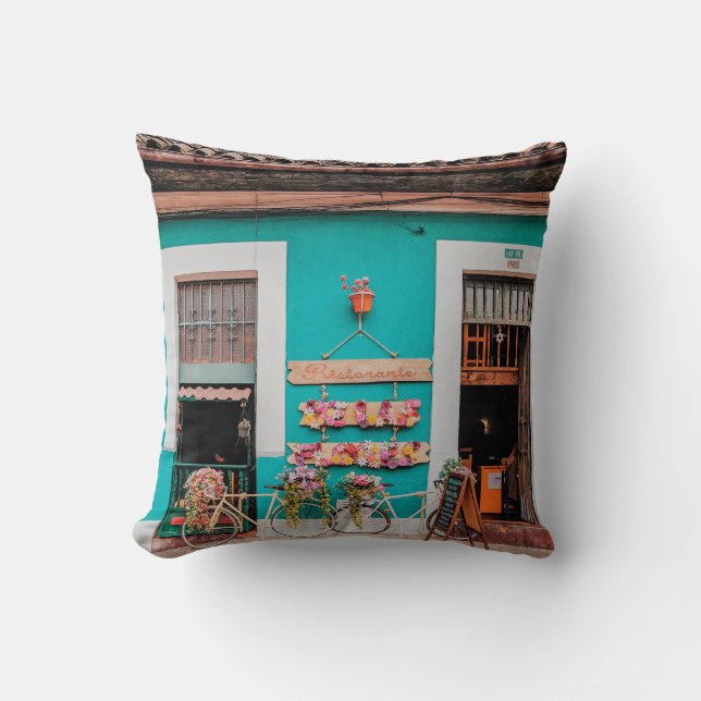 WHITE BICYCLE PARKED BESIDE TEAL PAINTED CONCRETE  CUSHION (Front)