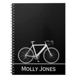 White Bike with Name on Black Notebook