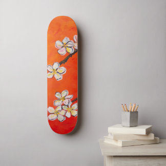 White blossoms on orange red spring background skateboard