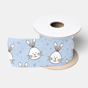 White bunny heads on blue satin ribbon