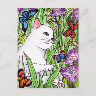 White cat chasing butterflies amongst flowers postcard