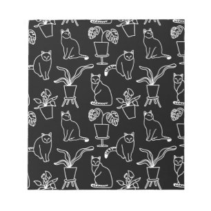 White cats on black notepad