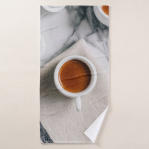 WHITE CERAMIC TEACUP FILLED WITH RED LIQUID BATH TOWEL