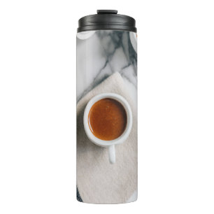 WHITE CERAMIC TEACUP FILLED WITH RED LIQUID THERMAL TUMBLER