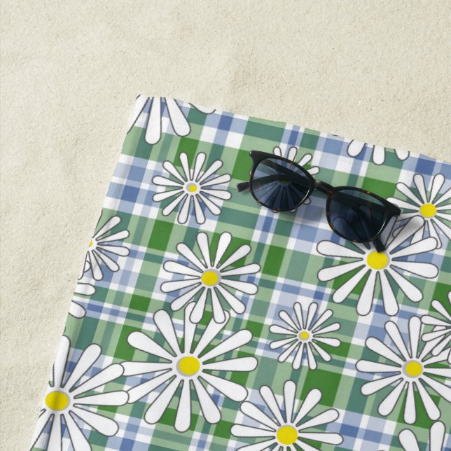 White chamomile flowers on a green blue chequered  beach towel (In Situ)