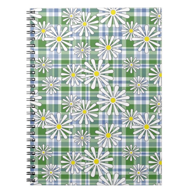 White chamomile flowers on a green blue chequered  notebook (Front)
