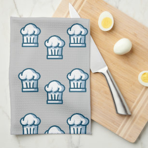 White chef hats on grey tea towel