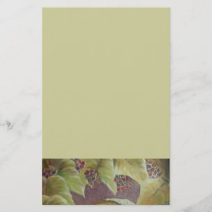White cloth with wine and bread surounded by green stationery