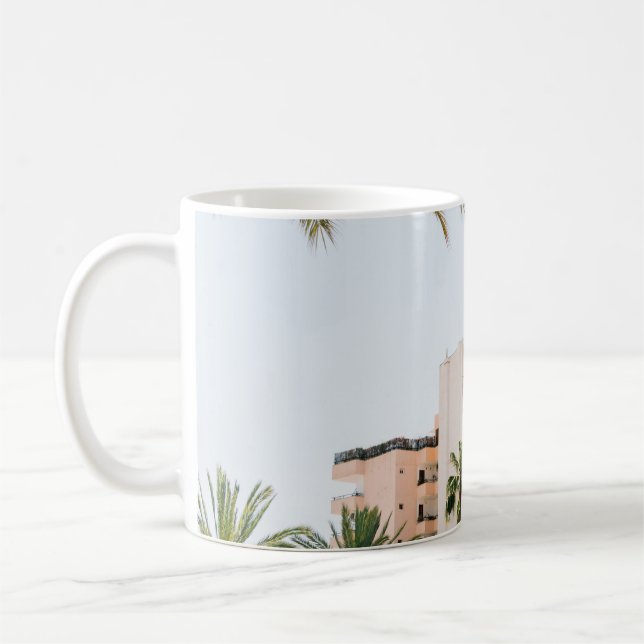WHITE CONCRETE BUILDING BESIDE GREEN PALM TREE UND COFFEE MUG (Left)