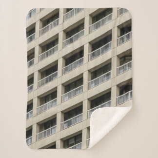 White concrete building during daytime sherpa blanket