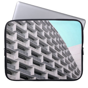 White concrete building with terraces laptop sleeve