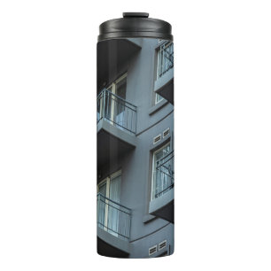 WHITE CONCRETE BUILDING WITH WHITE METAL RAILINGS THERMAL TUMBLER