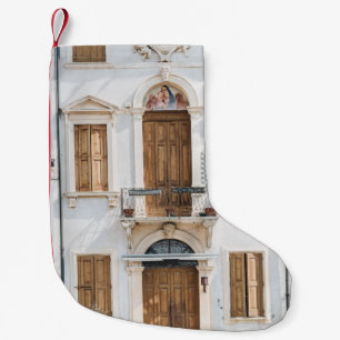 WHITE CONCRETE BUILDING WITH WOODEN DOORS AND WIND SMALL CHRISTMAS STOCKING