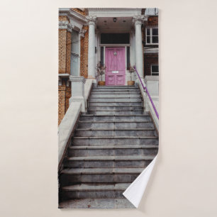 WHITE CONCRETE HOUSE SHOWING CLOSED PURPLE WOODEN BATH TOWEL