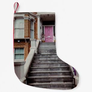 WHITE CONCRETE HOUSE SHOWING CLOSED PURPLE WOODEN  SMALL CHRISTMAS STOCKING