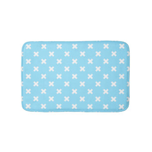 White cross stitches on baby blue bath mat