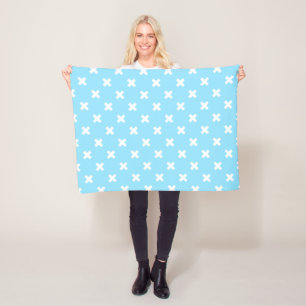 White cross stitches on baby blue fleece blanket